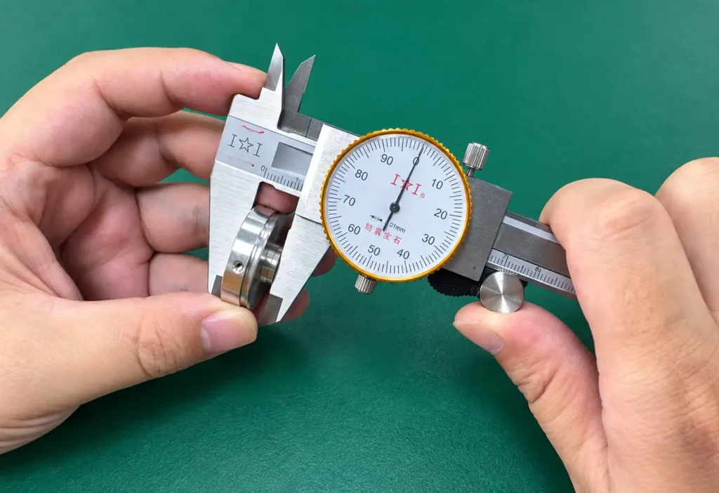 Quality Control caliper measuring cnc machined metal part